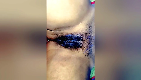 A hairy indian babe is getting her wet ass filled with some water