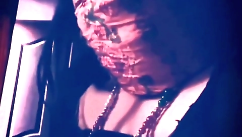 Skinny brunette with big boobs is using a small device