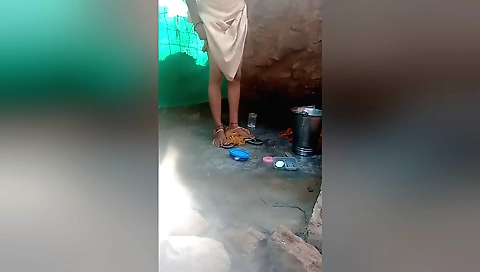 Indian girl in bikini bathing outside in her village
