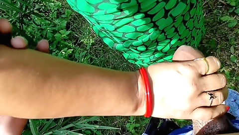 Handjob in the outdoor porn video of a brunette girl