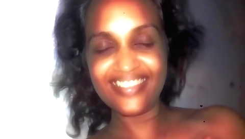 Indian brunette with a delicious smile is alone in the room